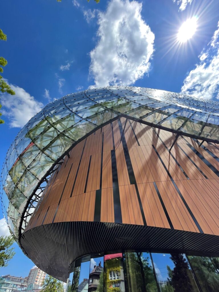 Exterior Office Design Facade Trespa Compact Wood Decors NW08 Italian Walnut Mat Lumen L90.0.0 Metropolis Black Specular Cavatina Hall Arch a