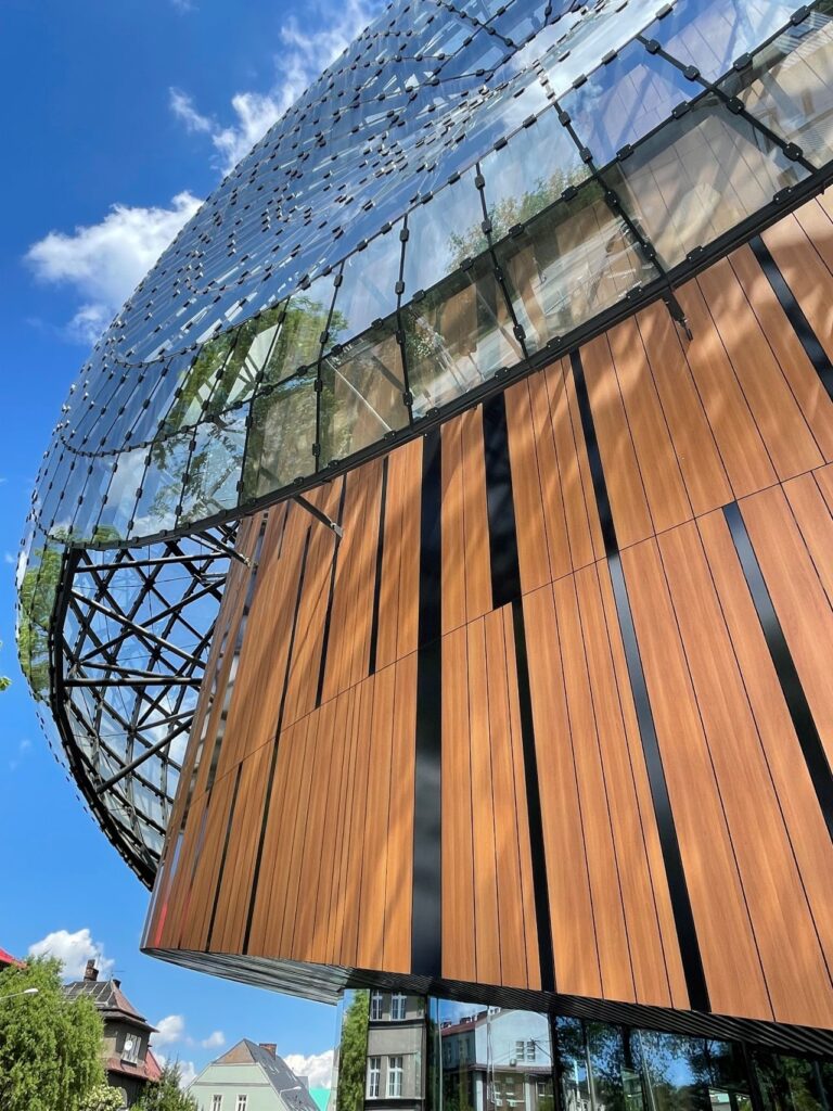 Exterior Office Design Facade Trespa Wall Cladding Compact Wood Decors NW08 Italian Walnut Mat Lumen L90.0.0 Metropolis Black Specular Cavatina Hall Arch c